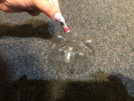 Upcycled Plastic Bottle Jewelry Stand - making hole in the middle of the bottle bottoms