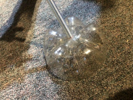 Upcycled Plastic Bottle Jewelry Stand - screwing the rod through the middle of the two liter bottle