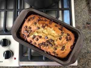 A baked loaf of banana bread with chocolate chips.