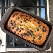 A baked loaf of banana bread with chocolate chips.