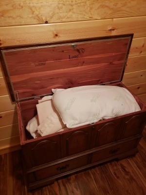 A Lane chest with linens inside.