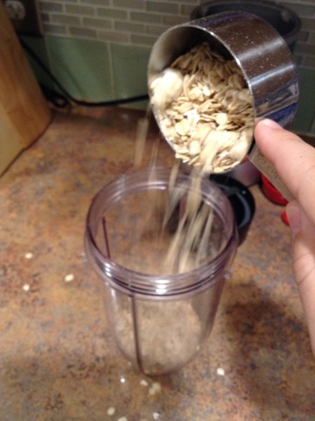 Adding oats to a blender container.