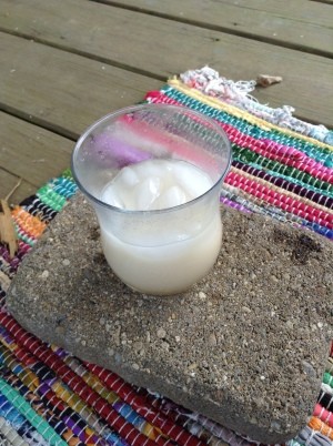 A glass of oat milk on ice.