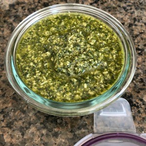 A completed bowl of basil garlic parmesan sauce.