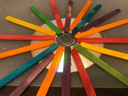 Hanging CD Reflective Garden Decoration - CD with lots of colorful craft sticks glued in place