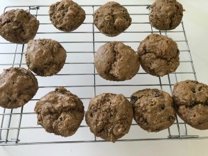 A cooling rack of baked muffins.