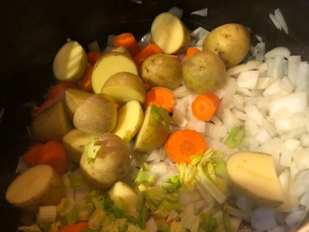 Potatoes, carrots and celery in a pan.