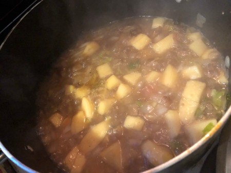 Cooking the curry in a pan.