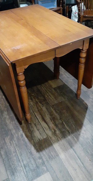 A dining table with the sides down.