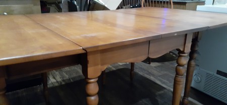 A dining table with the sides up.