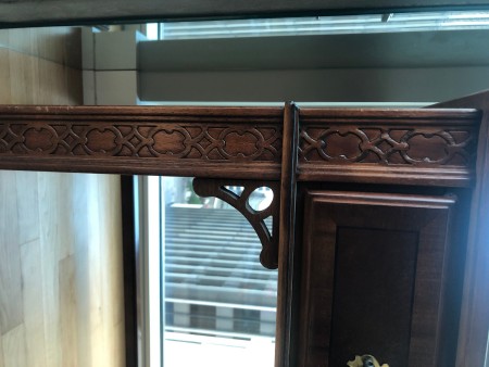 The decorative front to a wooden desk.