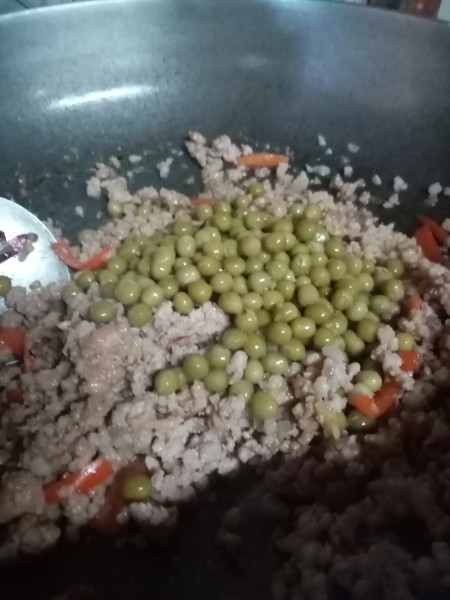 Adding ingredients into a frying pan.