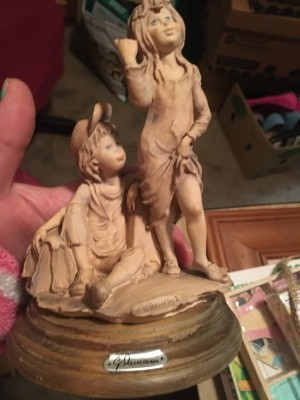 A figurine that shows two hitchhiking children.