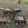 A rusty piece of farm equipment in a field.