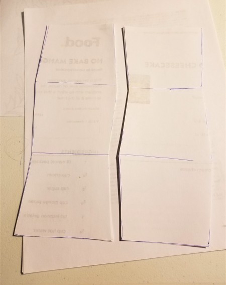 Paper being cut to the size of the box.