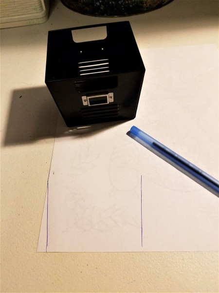 Marking out cutting lines on a piece of scrap paper.