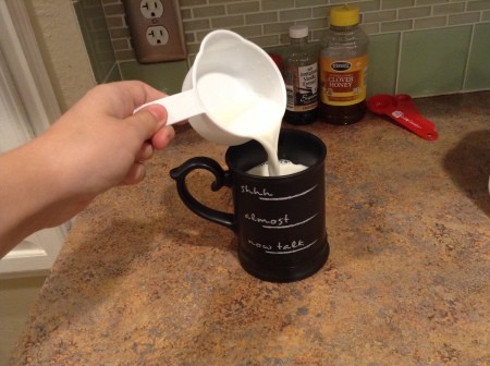 Adding milk to a coffee cup.