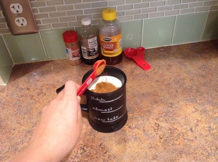 Adding cinnamon to the milk.