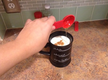 Adding honey to the milk mixture.