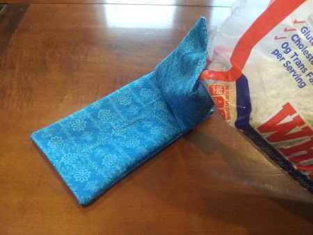 Heatable Rice Sack For Your Neck - pouring uncooked rice into the bag