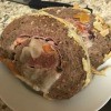 Two slices of stuffed meatloaf on a plate.