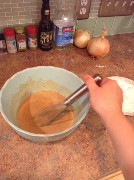 Mixing the batter for onion rings.