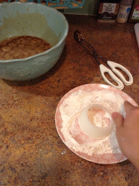 Dredging onion rings in flour.