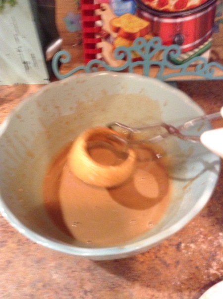 Dredging onion rings in batter.