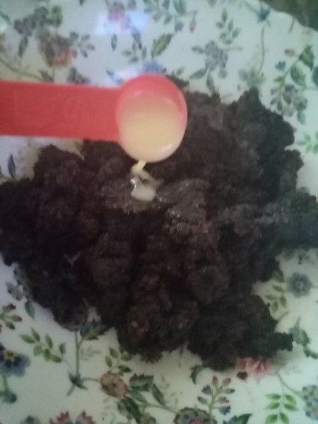 Adding condensed milk to the cake mixture.