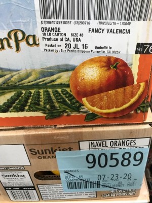 Two boxes of oranges with different pack dates.