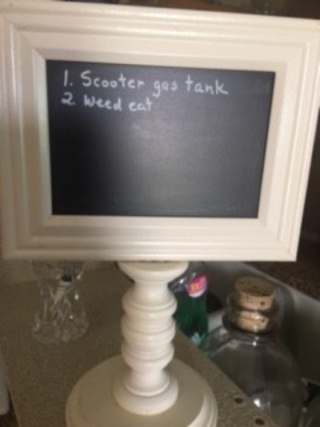 A chalkboard with tasks listed.