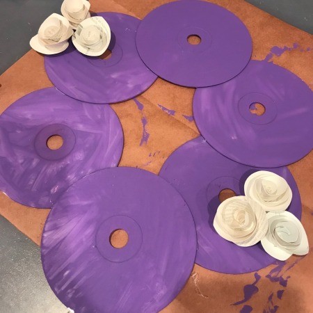 Painted CD Wreath - position the flowers and glue in place