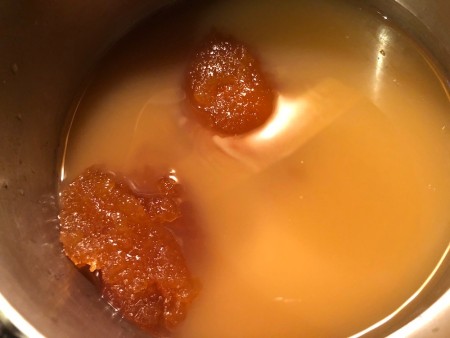 Adding honey to the apple cider vinegar mixture.