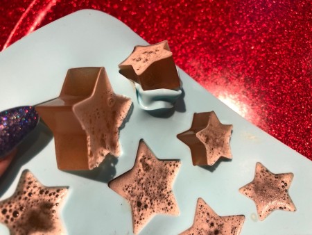 The finished gummies being removed from the silicone tray.