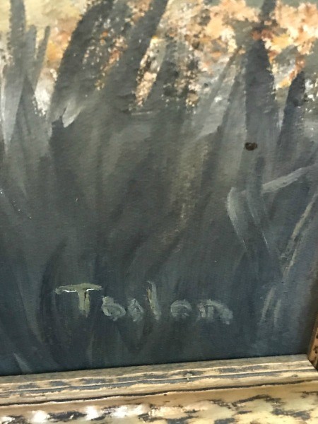 An artist's signature on a painting.