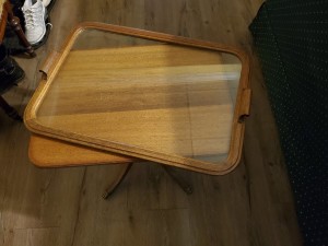 A small table with a glass tray on top.