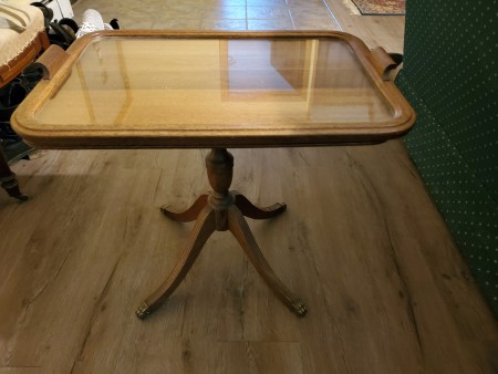 A small table with a glass tray on top.