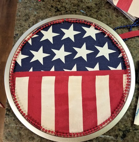 Pizza Pan Flag Wall Hanging - red fabric and beads glued in place
