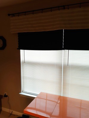 Black accordion shades on a west facing window.