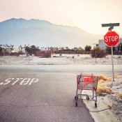 An abandoned grocery cart on the road.