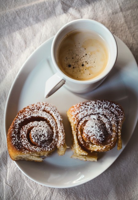 Coffee and cinnamon rolls on a plate.