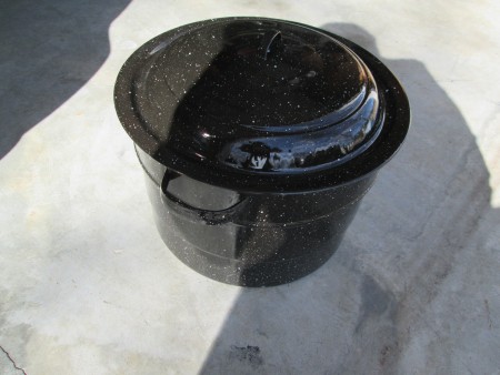 A large metal pot before being painted.