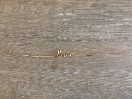 Minimalist Clip Desk Decor - copper wire cut and bent to form the word "love"