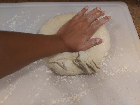 Kneading the ball of dough.