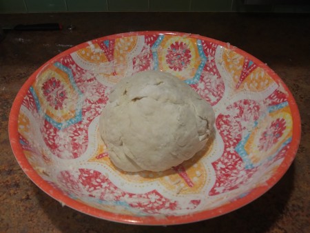 Forming a ball of dough in the bowl.