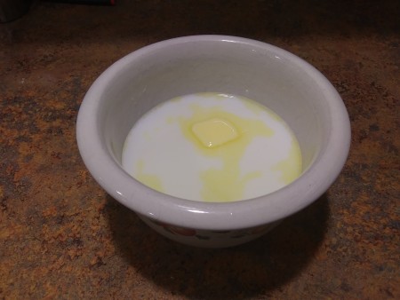 Milk and melted butter in a bowl.