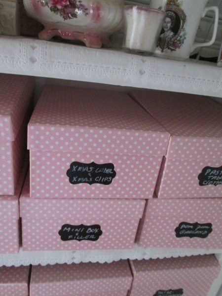 Pink and white shoe boxes with labels.