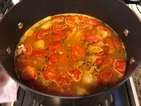 Cooking a pan of tomato soup.