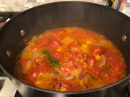 Cooking a pan of tomato soup.