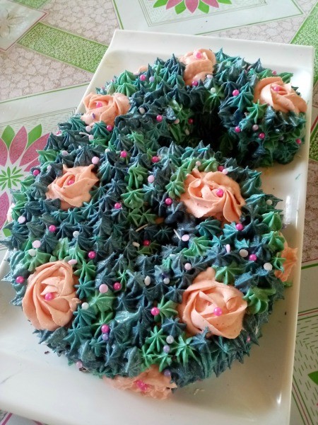 Number Cake Craft - number 6 decorated with pink flowers and blue and green piped on frosting